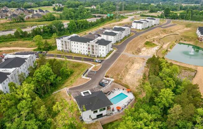 an aerial view of the apartments and a pool in the middle of the city