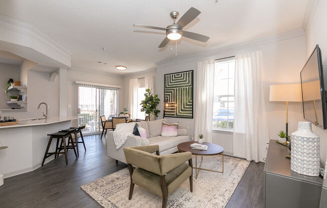 a living room with a couch and a ceiling fan at Deerfield Village, Alpharetta