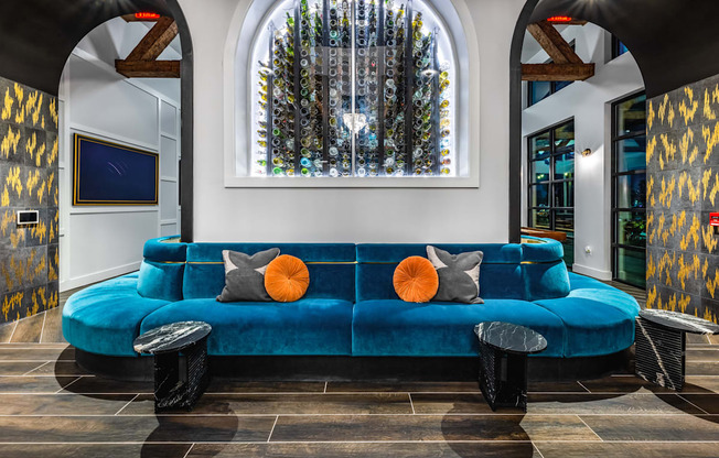 a living room with a blue couch and a large window