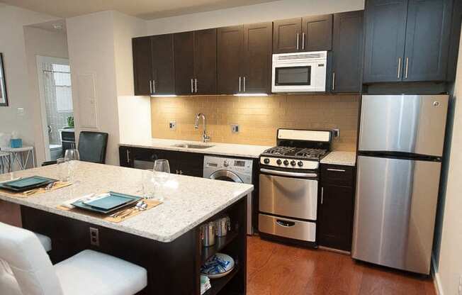 a kitchen with a stove a refrigerator and a sink