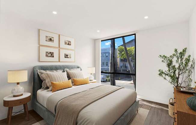 A bedroom with a large bed and a view of the outside.