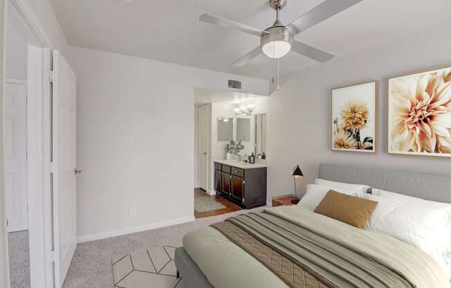 a bedroom with a large bed and a ceiling fan