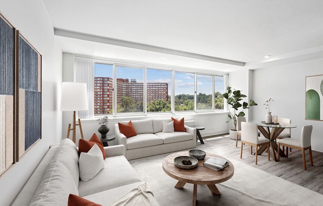 a living room with a couch and a table and a large window