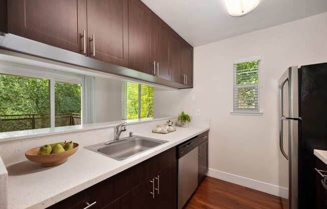 Kitchen with quartz counters with stainless sink and a window