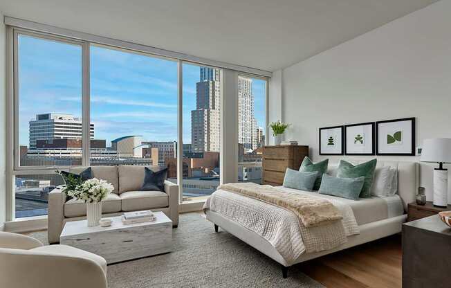 A bedroom with a large bed and a view of the city.