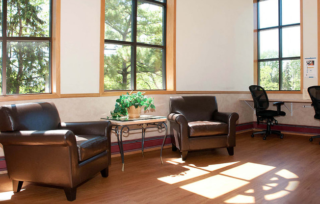 Community room with leather chairs and desk chairs