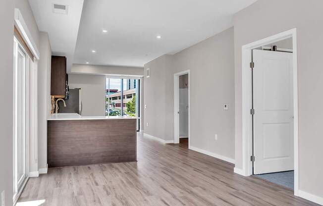 A spacious room with a reception desk and a door leading to another room.