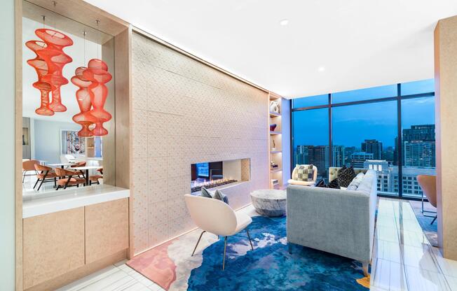 Sky lounge with dramatic city views, a statement fireplace, and curated furnishings creating a sophisticated setting for gathering above the Atlanta skyline.