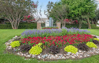 a flower garden in front of a house