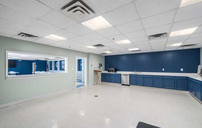 an empty room with a sink and a counter in the middle of it