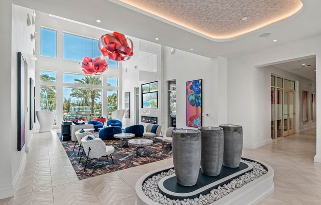 a living room filled with furniture and large windowsat Altis Grand Lake Willis, Orlando, FL