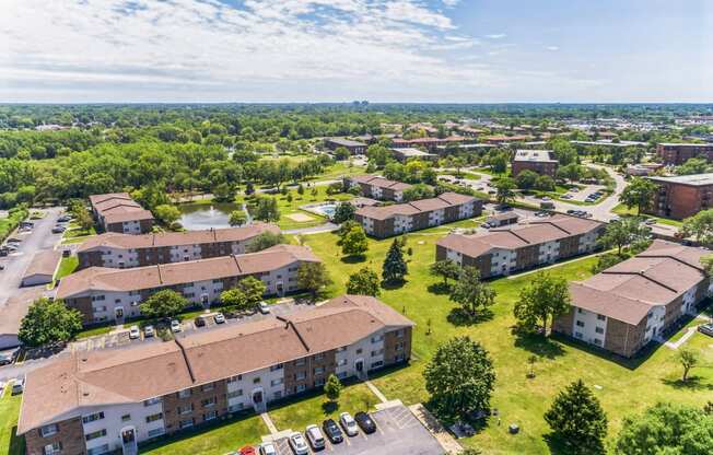 an aerial view of a group of buildings in a city at St Charles Square Apartments, Carol Stream, IL