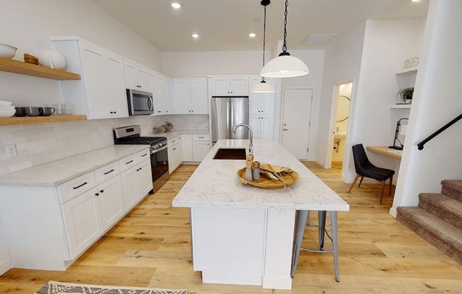 a large white kitchen with a marble counter top at Novella Biltmore, Phoenix, AZ