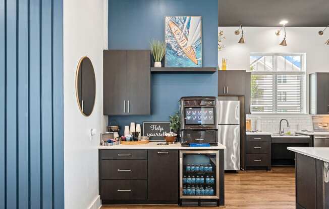 a kitchen with blue walls and a stainless steel refrigerator