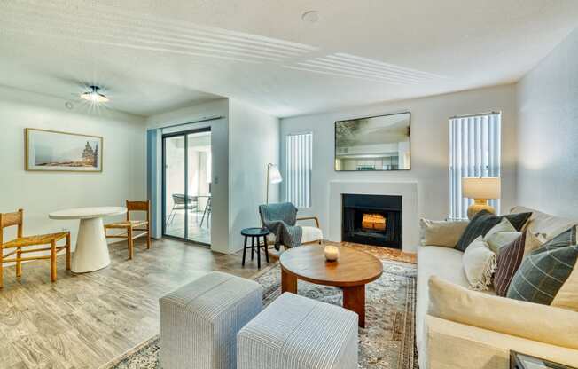 a living room with a couch and chairs and a fireplace