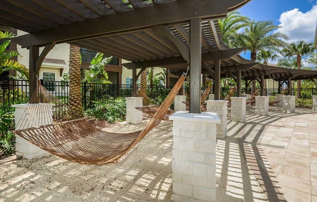 a hammock is set up on a patio in front of a building  at Cabana Club - Galleria Club, Jacksonville, FL