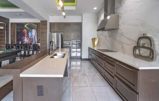 a large kitchen with marble counter tops and a dining room with a table and chairs at The Hendrix, Atlanta, GA, 30329