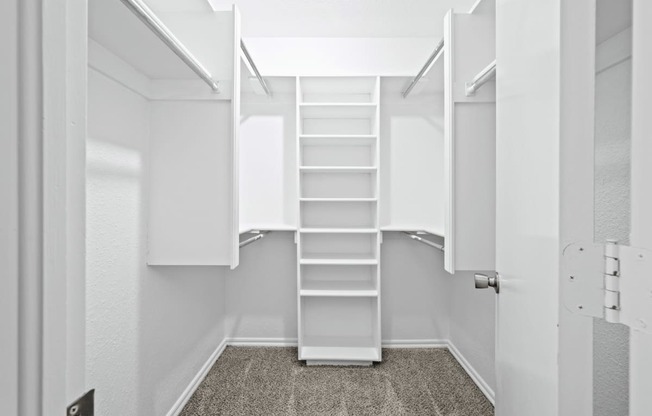 a walk in closet with white shelves and a spiral staircase at Diamond Ridge Townhomes, Oklahoma City, 73114