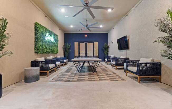 A room with a green wall hanging and a ceiling fan.