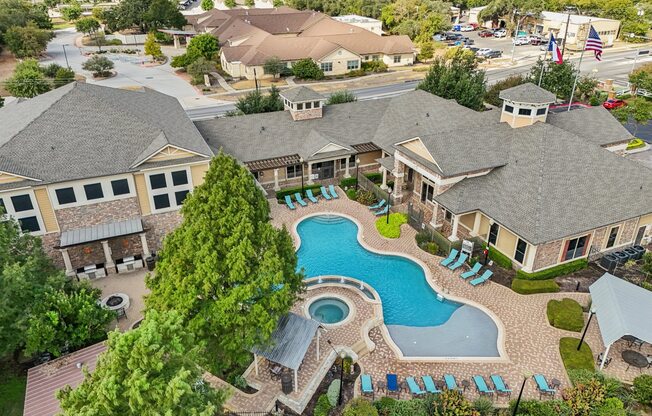 A large house with a pool in the middle of it.