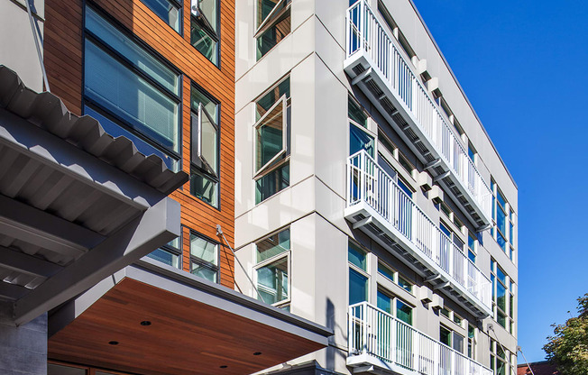 a view of the side of a building with balconies and a sidewalk at The Hayes on Stone Way, Seattle