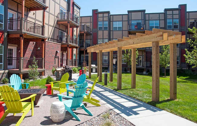 A patio with a wooden pergola and several chairs.