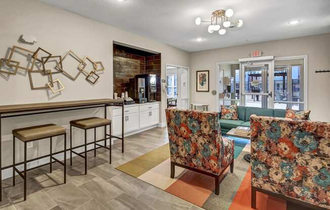 a living room with furniture and a bar with stools