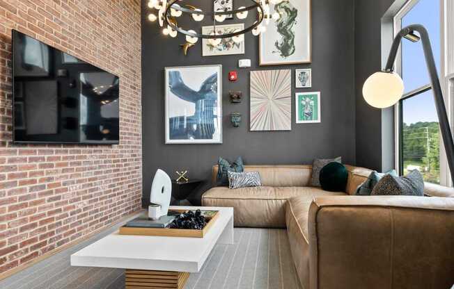 A living room with a brown couch and a white coffee table.
