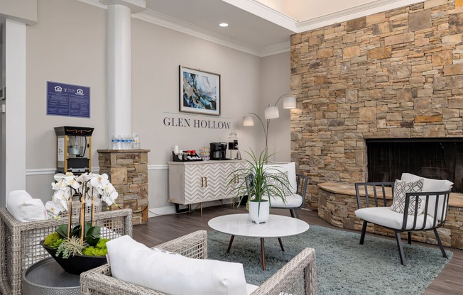 a living room with a stone fireplace and a coffee table at Glen Hollow, Georgia