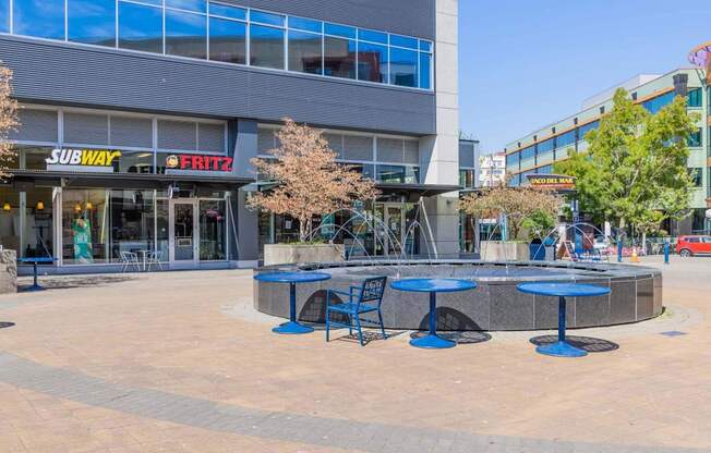 A Subway restaurant is located in a plaza with tables and chairs at Spyglass Hill Apartments, Bremerton, 98337