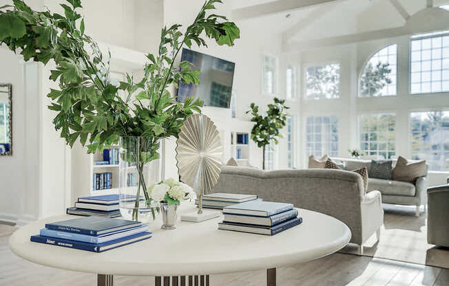 A living room with a white table and a plant on it.