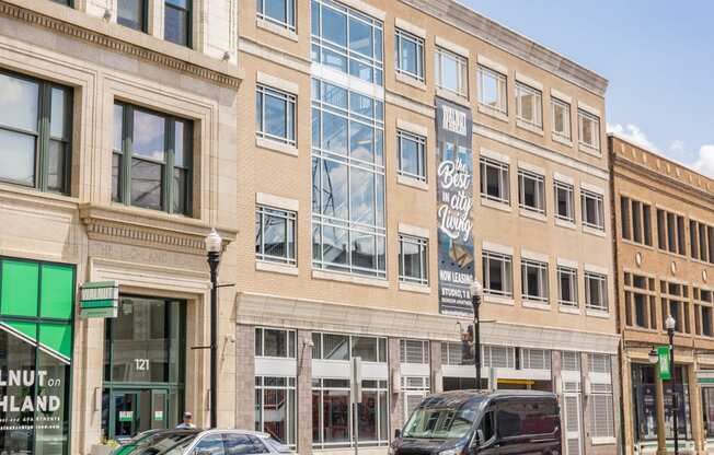 a city building with cars parked in front of it