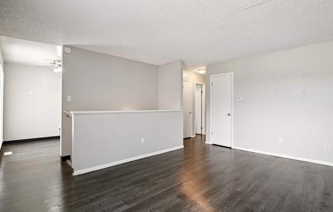 A room with a white wall and a wooden floor.