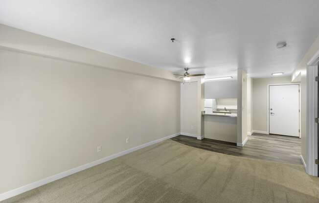 Unfurnished living area with a view into the kitchen in the background  at West Mall Place Apartment Homes, Washington