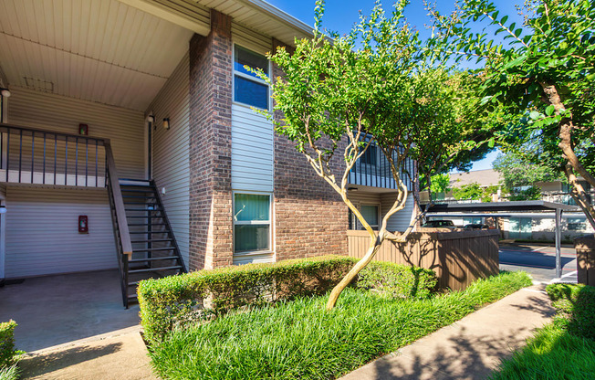 Apartment building exteriors showing patios, balconies and landscaping at Preston Park Apartments in the Far North Dallas neighborhood of Dallas, TX