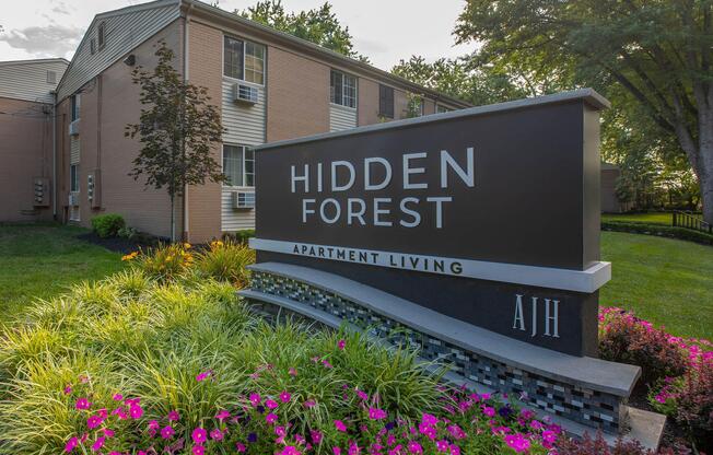 a sign on the side of a flower garden