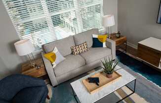 a living room with a couch and a coffee table at One Riverside Apartments, Chattanooga, TN, 37403