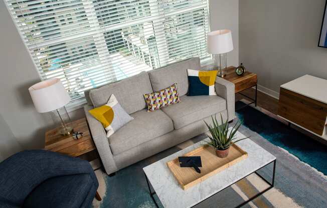 a living room with a couch and a coffee table at One Riverside Apartments, Chattanooga, TN, 37403