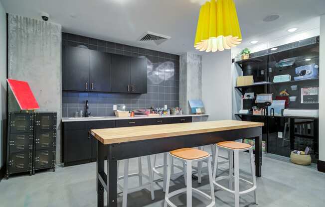 a kitchen with a long island with three stools in front of a counter top