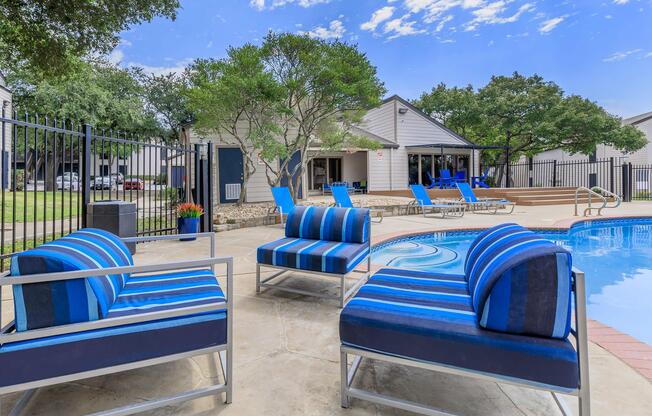 a blue bench in front of a pool