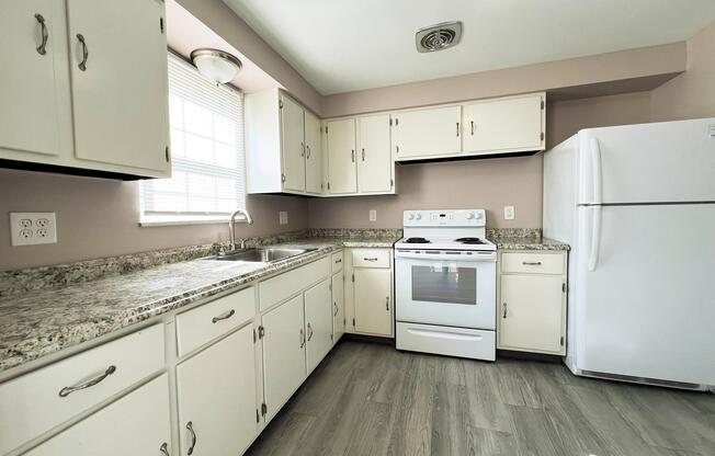 a kitchen with appliances and white cabinets