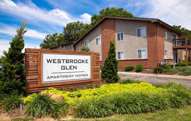 A sign for Westbrooke Glen Apartment Homes in front of a building.