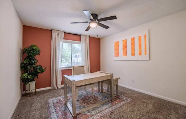 a dining room with a table and a ceiling fan