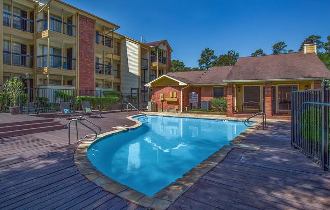 a house with a pool in front of a brick building