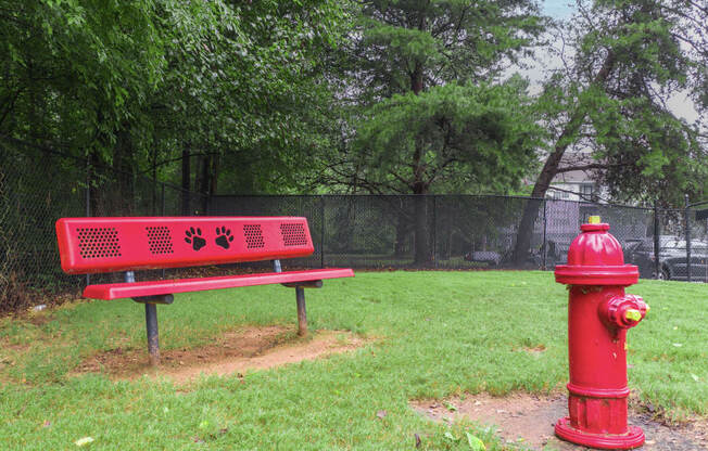 a red bench sitting next to a red fire hydrant
