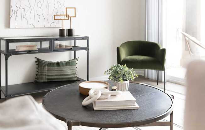 A black round table with a white phone and a book on it.
