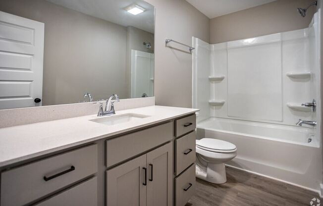 a bathroom with a sink toilet and a mirror