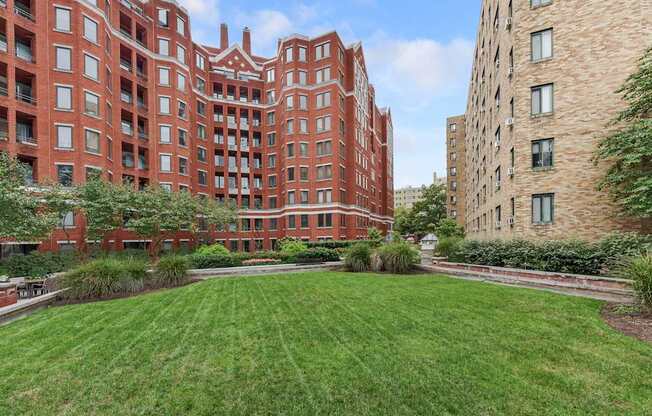 A red brick building with a green lawn in front.