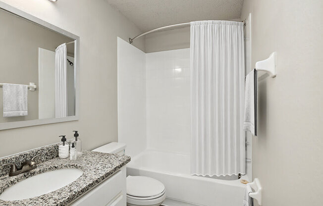 Model bathroom with a sink toilet and bathtub