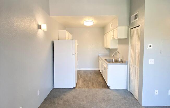 a kitchen with a sink and a refrigerator